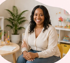 Ebony, pediatric occupational therapist, smiling in her therapy space